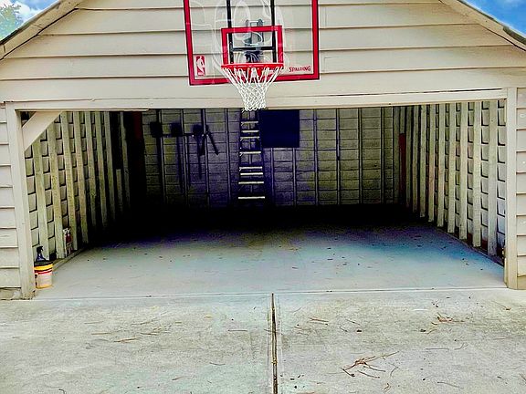 Two car garage behind house, up driveway.