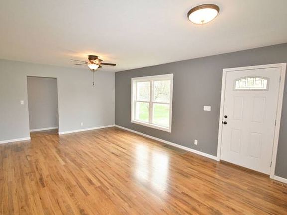 Calming gray colors are fresh on the walls and compliment the newly refinished wood floor nicely. White trim surrounds all the rooms and vinyl windows throughout the home. 