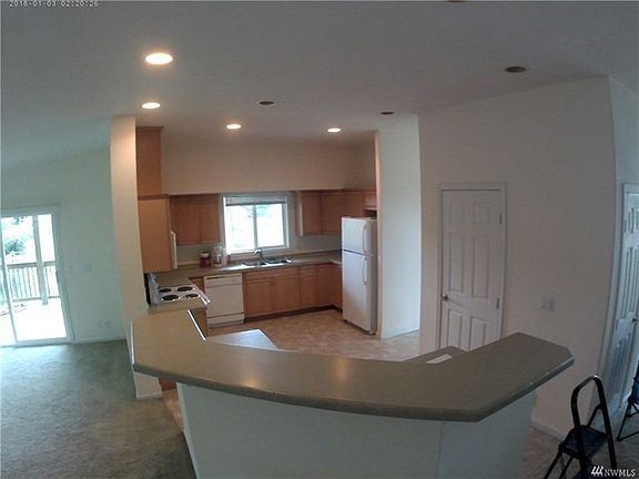 Kitchen island with open floor plan to living area and dinning room.