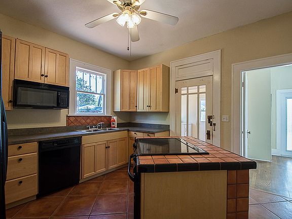 Kitchen with island cooktop and kenmore appliances