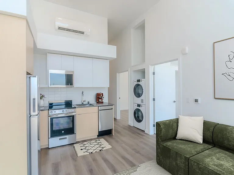 Spacious living room with a couch and kitchen at Alt Capitol Hill.