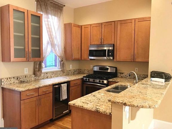 Kitchen with granite counters & stainless appliances including beverage cooler.