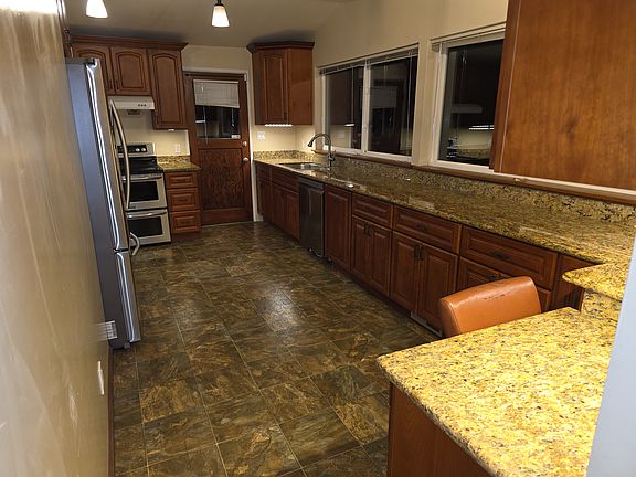 Large kitchen, stainless appliances, double oven, granite countertops, plenty of storage, built in desk.