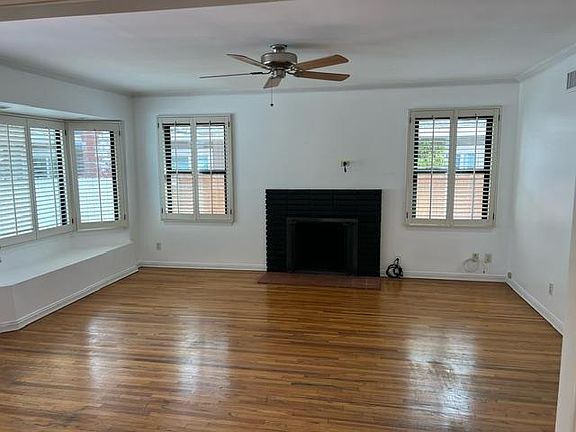 Living room wood burning fireplace, plantation shutter, bay window seat (new seat cushion not shown)