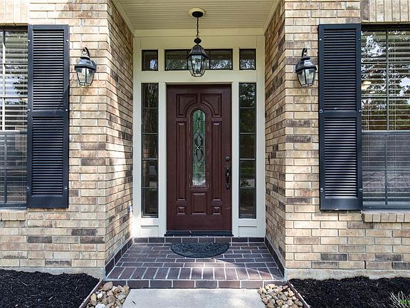 A covered entry leads to the low maintenance fiberglass leaded-glass front door.