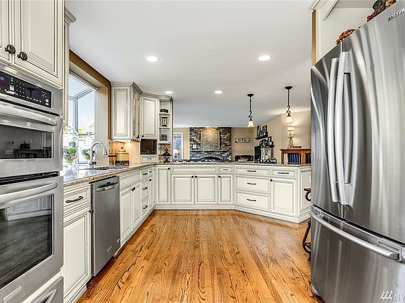 No detail was overlooked here. Note the custom cabinets and lighting. The upgraded appliances are stainless steel and include a gas cooktop and warming drawer. 