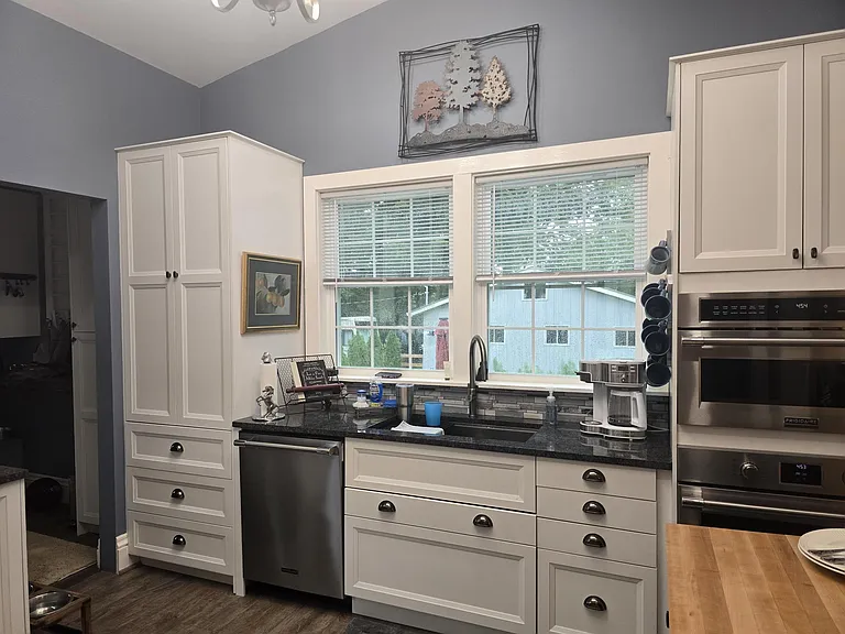 Full view of sink, dishwasher and coffee station.