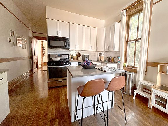 Sunlit island kitchen with quartz countertops