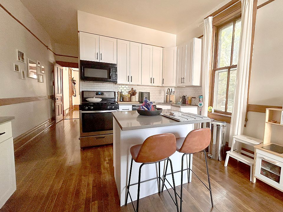 Sunlit island kitchen with quartz countertops