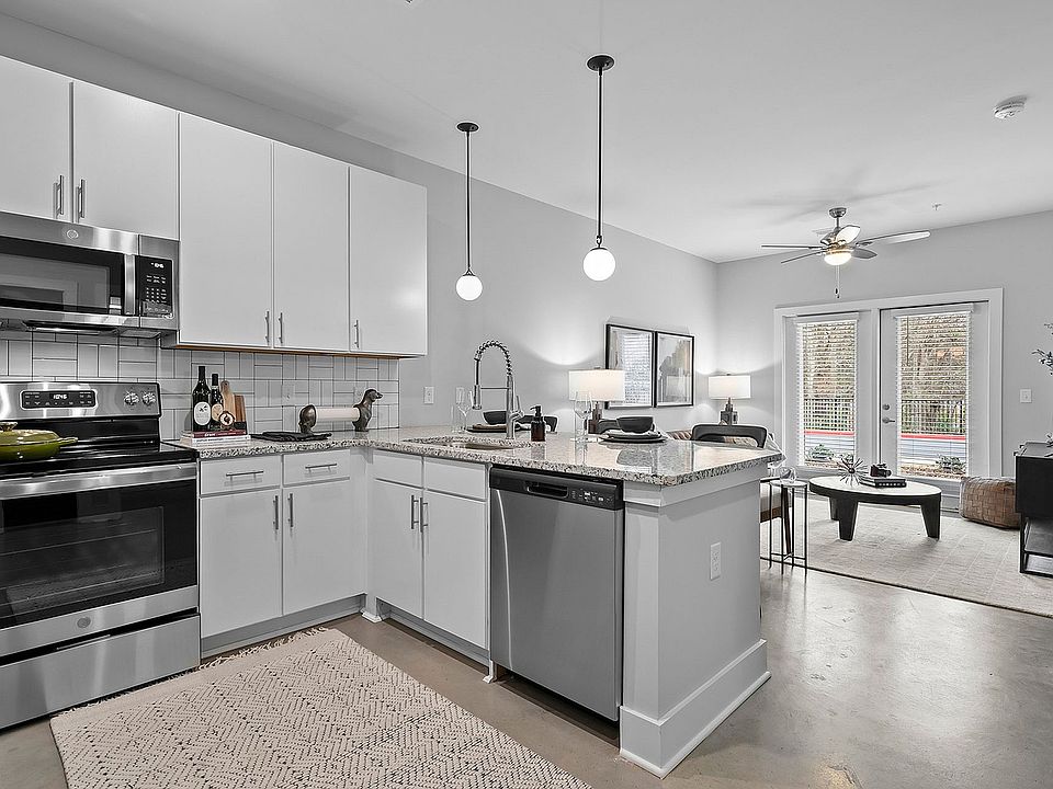 Kitchen with granite counters, stainless appliances, and modern cabinetry