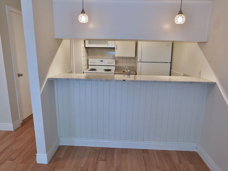 View of the kitchen and bar from the living room.