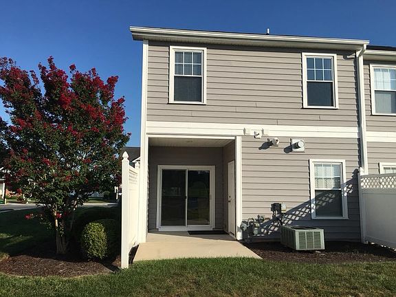 Rear elevation with covered porch, storage shed.
