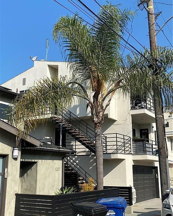 Outdoor staircase up one flight to the front door, over the 2 car garage. The second staircase goes to the deck.