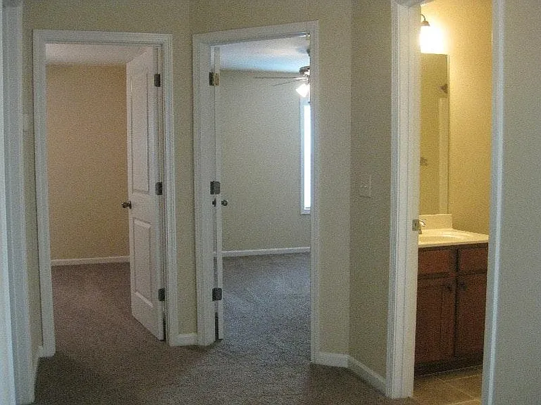 two almost equal sized bedrooms, left of restroom.