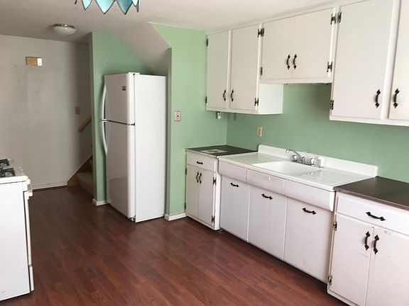 Kitchen with stove and refrigerator.