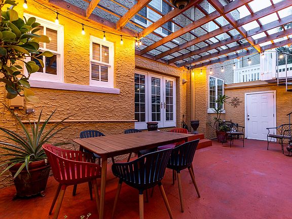 Side of house with pergola and outdoor table