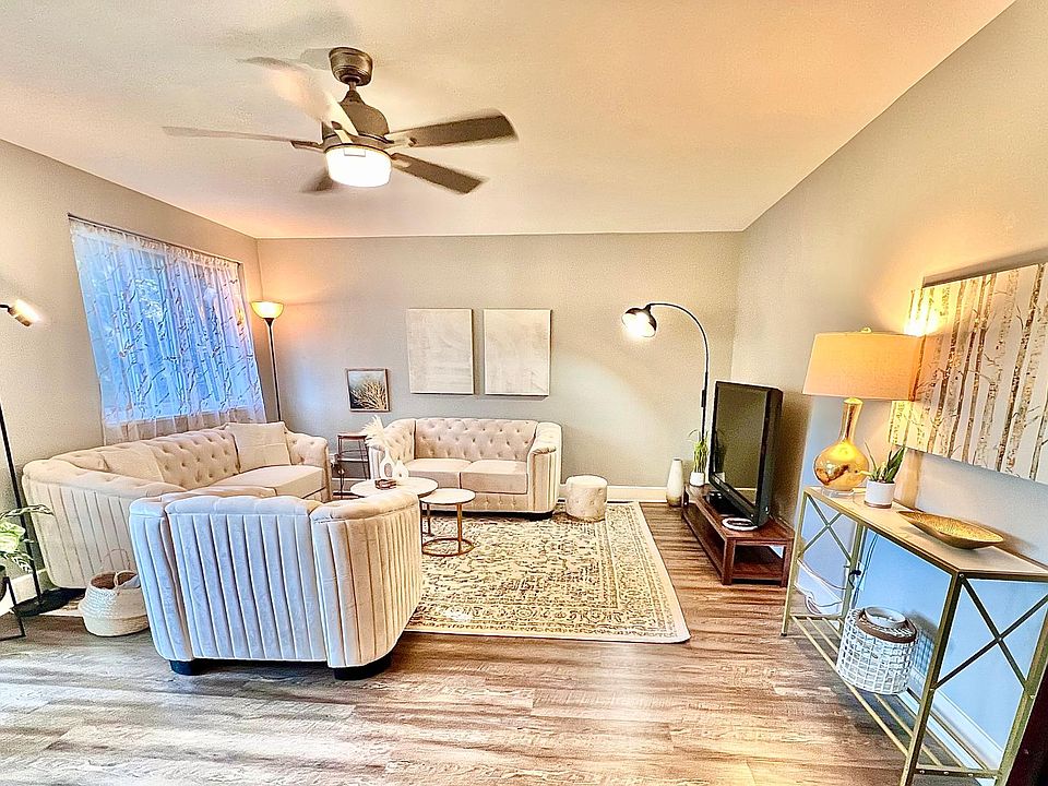 Living Room with Modern Tufted Couches and 55 inch Smart TV.