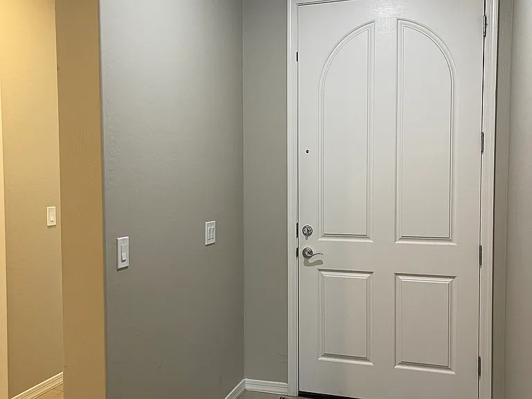 Secure front door with no transom windows. Two secluded bedrooms and secondary bath to the left off the hallway.
