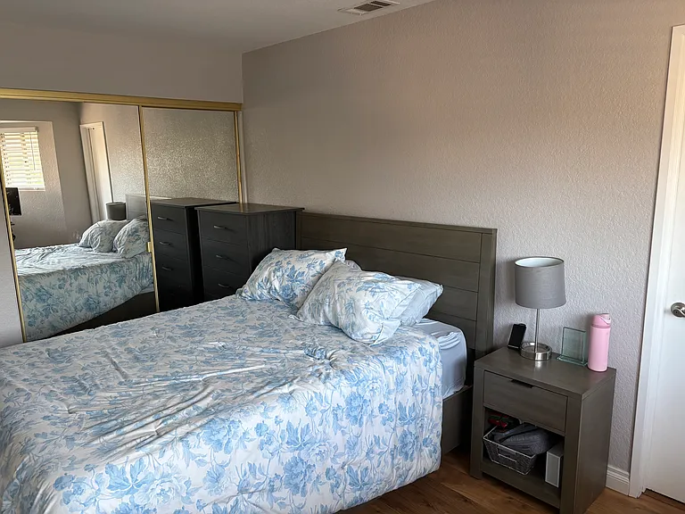 View of bedroom with mirrored wardrobe
