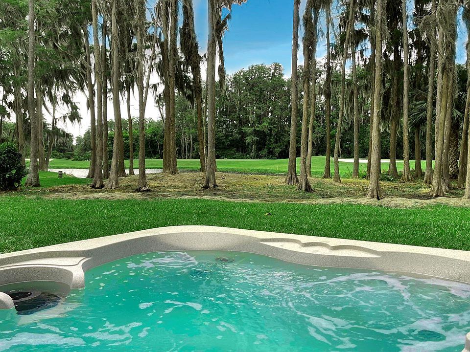 Back garden with hot tub jacuzzi overlooking lake and Saddlebrook Golf Resort Course.