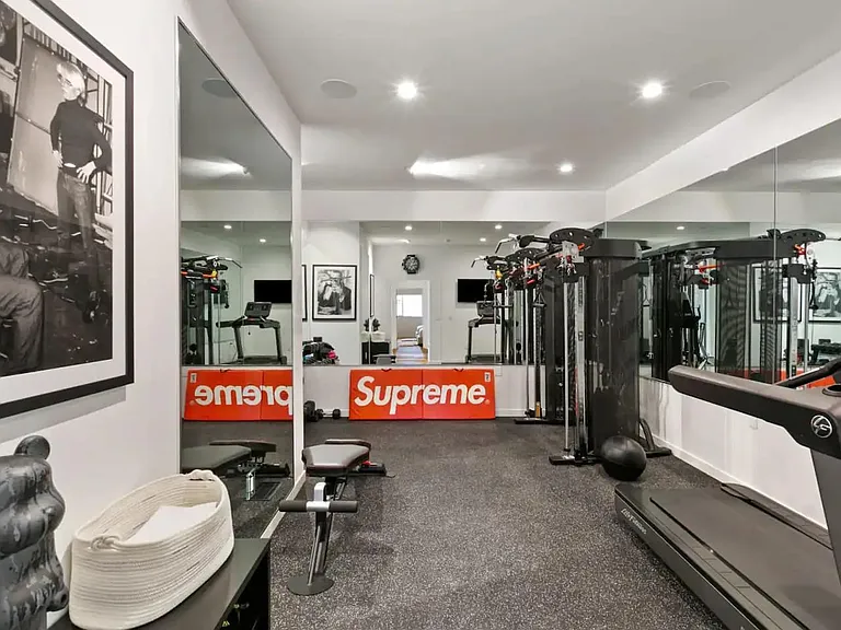 Fully equipped indoor gym for your fitness needs, including a treadmill, free weights up to 45 lbs, "Inspire" functional trainer machine, and exercise ball.