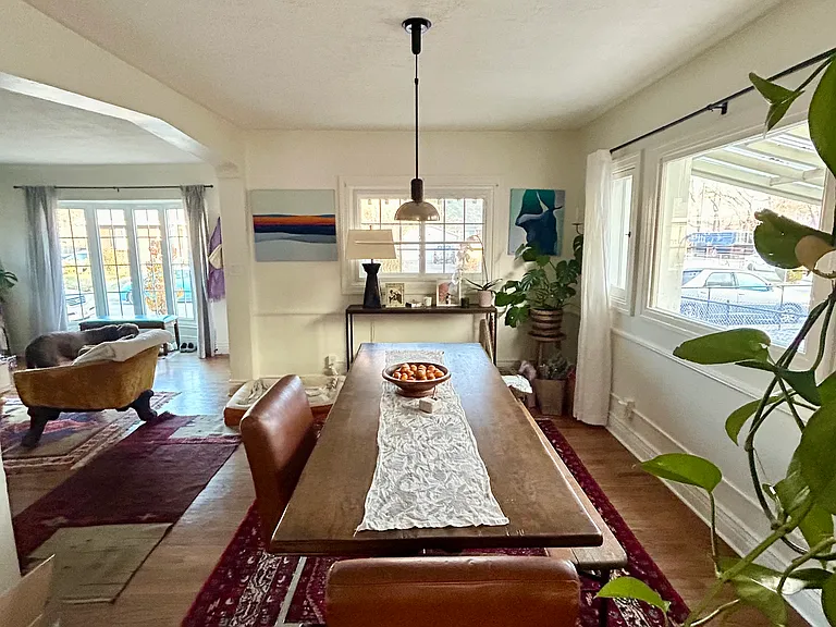 View of dining room and living room area from kitchen. Lots of bright, natural light!
