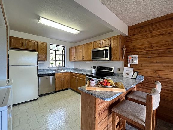Open kitchen. All appliances including the washer and dryer convey.