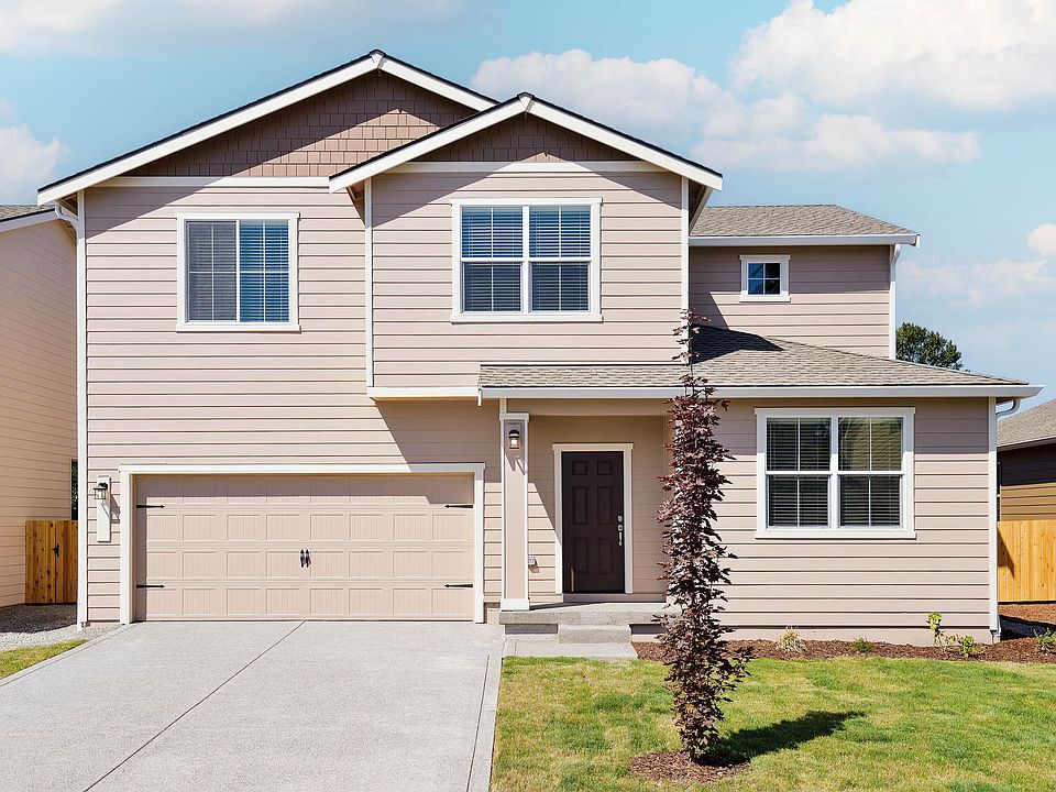 Beautiful two story home at Connell Park with siding and stone and front yard landscaping