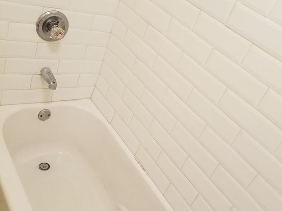 Bathroom with New Ceramic Tile, New Toilet, New Shower Tiles