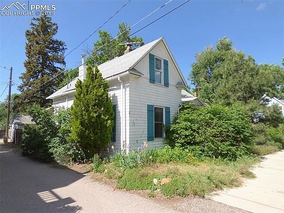 Side shot of house. Alley heading to back and garage.
