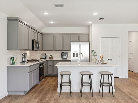 Kitchen in the Emmy II home plan by Trophy Signature Homes - REPRESENTATIVE PHOTO