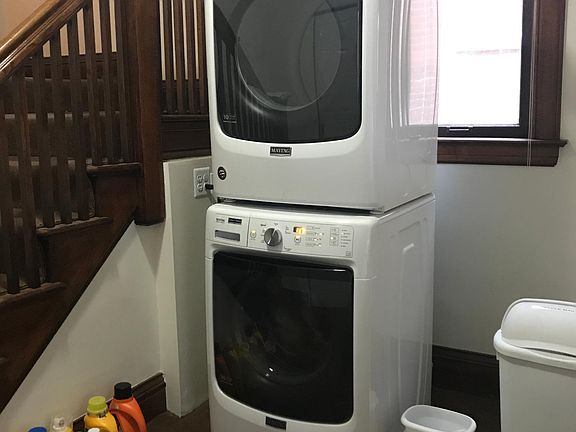 New full-size washer and dryer in foyer.