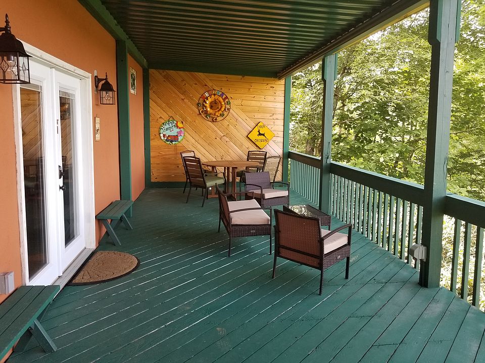 Private deck with a roof. The living room area now has a sectional couch with a coffee table. Enjoy outdoor dining while experiencing the incredible mouintain view