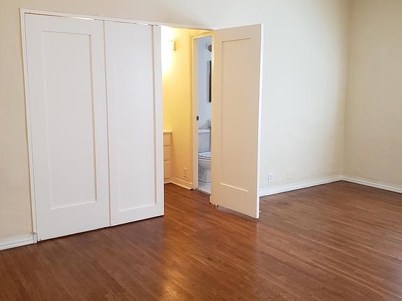Living area (view 2 from unit entry) showing entry to walk-in closet and bathroom