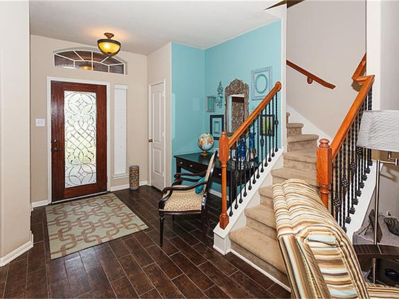 Entry is beautiful with glass door and wood grain tile