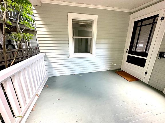 Front porch with tons of trees and other greenery along the sides