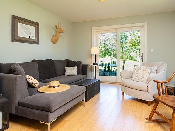 The living room is sun-splashed and sliders step out onto a large native western facing stone patio.