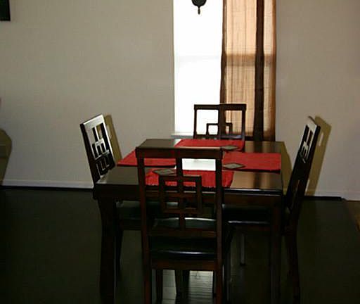 Dining room features a lovely updated light fixture and custom drapes