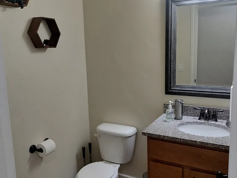 Laundry room with new LG Conveniently located bathroom by the garage, with benches, a coat rack, and a half bath_perfect for managing outdoor gear and storage needs.