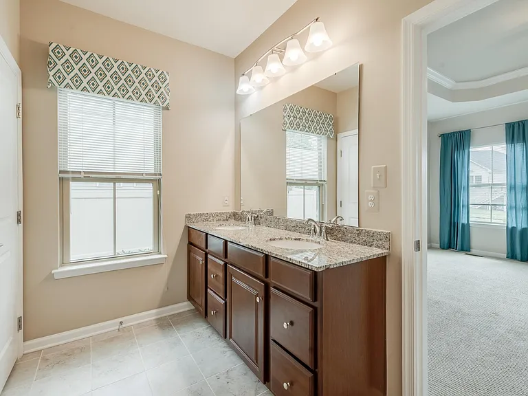 Owner's Bathroom with Double Sinks and Granite Countertop