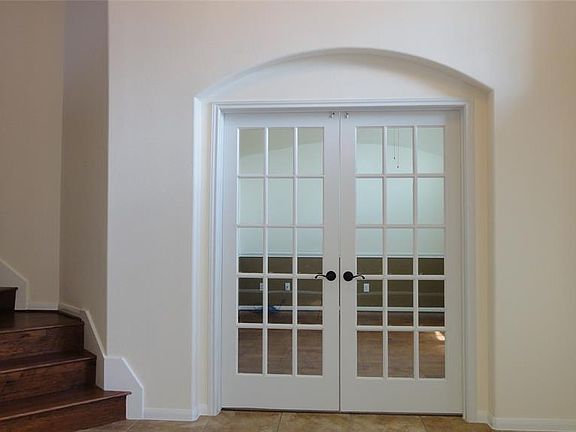 Just look how cozy the double french doors fit into the art niche...elegance, style and private.