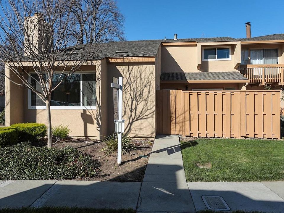 Entrance to the property. Includes a Front Patio. Currently has nice landscaping including flowering rose bushes.
