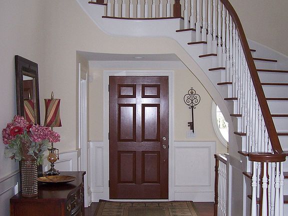 Two story entry with wood floors & curved stairway