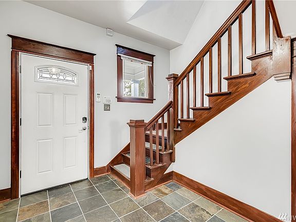 Enter to a foyer of slate tiled flooring and classic dark rich original millwork full of old world charm.