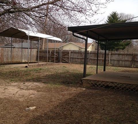 back yard with tall carport