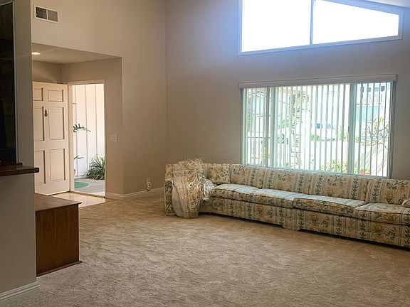 Spacious and bright living room with cathedral ceiling, recessed lighting