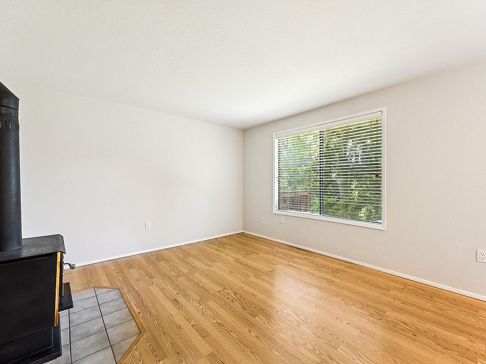Main living areas overlook restful yard and beautiful trees