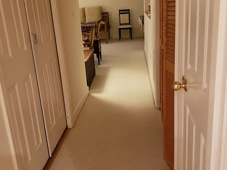 Hallway with laundry and additional storage space.