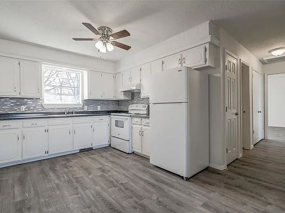 Kitchen with refrigerator and range