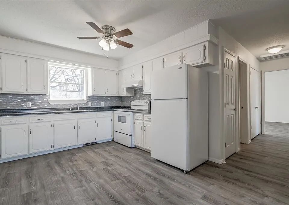 Kitchen with refrigerator and range